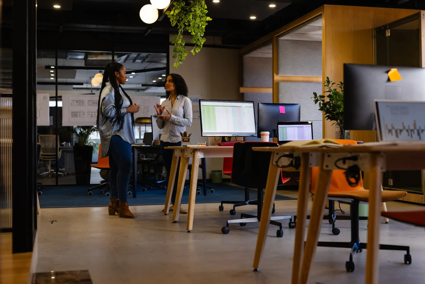 Colleagues discussing work in a modern office